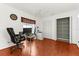 Home office with hardwood floors, large window, and closet storage space at 8240 Cypress Lake Dr, Sarasota, FL 34243