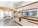 Bright kitchen featuring white cabinetry, stainless steel sink, and view to an adjacent dining area at 8240 Cypress Lake Dr, Sarasota, FL 34243