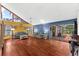 Bright living room with vaulted ceilings, hardwood floors, and access to a screened-in patio at 8240 Cypress Lake Dr, Sarasota, FL 34243