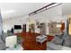 Open-concept living room with hardwood floors, ample seating, and a bright, airy atmosphere at 8240 Cypress Lake Dr, Sarasota, FL 34243