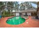 An outdoor screened-in pool area with a pool, hot tub, and patio furniture in the backyard at 8240 Cypress Lake Dr, Sarasota, FL 34243
