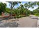 Street view of the Country Oaks community sign along a tree lined road with lush landscaping at 8240 Cypress Lake Dr, Sarasota, FL 34243