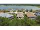 Aerial view of homes near a pond, showcasing landscaping and screen-enclosed pools at 9236 Raes Creek Pl, Palmetto, FL 34221