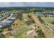 Scenic aerial view of a golf course community featuring lush greenery, ponds, and well-maintained homes at 9236 Raes Creek Pl, Palmetto, FL 34221