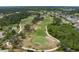 Stunning aerial shot of the golf course highlighting the manicured greens and surrounding natural landscape at 9236 Raes Creek Pl, Palmetto, FL 34221