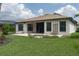 Picturesque backyard showcasing a tiled patio, manicured lawn, and lush landscaping, ideal for outdoor living at 9236 Raes Creek Pl, Palmetto, FL 34221
