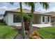 Serene backyard with a tiled patio, vibrant plants, and a neatly landscaped lawn, perfect for relaxation at 9236 Raes Creek Pl, Palmetto, FL 34221