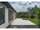 Inviting backyard featuring a tiled patio, lush landscaping, and a well-maintained lawn for outdoor enjoyment at 9236 Raes Creek Pl, Palmetto, FL 34221