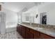 Bathroom featuring double sinks, granite countertops, a bathtub, and a walk-in shower at 9236 Raes Creek Pl, Palmetto, FL 34221