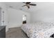 This bedroom features a ceiling fan, plush carpet, access to an en suite bath, and ample natural light at 9236 Raes Creek Pl, Palmetto, FL 34221