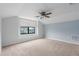 Spacious bedroom with plush carpeting and a large window offering neighborhood views at 9236 Raes Creek Pl, Palmetto, FL 34221