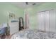 Bedroom with green walls, large closet, an adjacent desk and a mirror at 9236 Raes Creek Pl, Palmetto, FL 34221