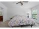 Bedroom with a large bed, a window with blinds and access to a private bathroom at 9236 Raes Creek Pl, Palmetto, FL 34221