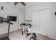 Bright bedroom with a closet, exercise bike, and treadmill for a home gym setup at 9236 Raes Creek Pl, Palmetto, FL 34221
