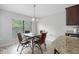 The dining area has a window with natural light and seating for four with a view of the kitchen island at 9236 Raes Creek Pl, Palmetto, FL 34221