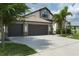 Charming single-Gathering home with lush landscaping, a 3-car garage and stone facade at 9236 Raes Creek Pl, Palmetto, FL 34221