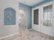 Bright foyer boasts beautiful double doors, tiled floors, and arched entryway leading to other areas at 9236 Raes Creek Pl, Palmetto, FL 34221