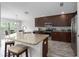 Spacious kitchen with granite countertops, stainless steel appliances, and breakfast bar with seating at 9236 Raes Creek Pl, Palmetto, FL 34221