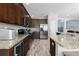 The kitchen offers stainless steel appliances, granite countertops, wood cabinets, and tiled floors at 9236 Raes Creek Pl, Palmetto, FL 34221