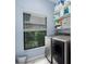 Well-equipped laundry room featuring modern washer and dryer, plus ample storage shelves at 9236 Raes Creek Pl, Palmetto, FL 34221