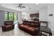Open living room with tile floors adjacent to a kitchen and sliding doors to the outdoor patio at 9236 Raes Creek Pl, Palmetto, FL 34221