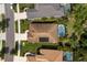 Aerial view of a home with solar panels and a screened pool surrounded by manicured landscaping and a lush green lawn at 12261 Stuart Dr, Venice, FL 34293
