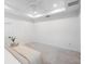 Bright white bedroom features a tray ceiling, neutral carpet, and simple finishes at 12261 Stuart Dr, Venice, FL 34293