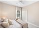 Neutral bedroom featuring a ceiling fan, soft, carpet, closet and a window dressed with curtains at 12261 Stuart Dr, Venice, FL 34293