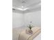 Bright white bedroom features a tray ceiling, neutral carpet, and simple finishes at 12261 Stuart Dr, Venice, FL 34293