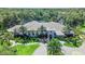 Elegant clubhouse surrounded by tropical landscaping, offering a welcoming entrance and luxurious amenities at 12261 Stuart Dr, Venice, FL 34293
