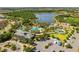 Stunning aerial view of the community pool area with water slides, splash pads, and ample seating for relaxation at 12261 Stuart Dr, Venice, FL 34293