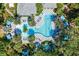 Unique community pool layout surrounded by palm trees, lounge chairs, and checkered patio for ultimate relaxation and enjoyment at 12261 Stuart Dr, Venice, FL 34293