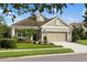 Charming single-story home showcasing a well-maintained lawn, landscaped garden, and a two-car garage at 12261 Stuart Dr, Venice, FL 34293