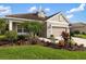 Charming single-Gathering home features a well-manicured lawn, lush landscaping, and a welcoming two-car garage at 12261 Stuart Dr, Venice, FL 34293
