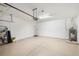 Clean two-car garage with epoxy flooring, shelving, and storage space at 12261 Stuart Dr, Venice, FL 34293