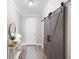 Hallway featuring a sliding barn door and console table at 12261 Stuart Dr, Venice, FL 34293
