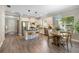 Open concept kitchen features white cabinetry, stainless steel appliances, bar seating, and a breakfast nook at 12261 Stuart Dr, Venice, FL 34293