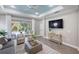 Bright living room featuring modern decor, a ceiling fan, and sliding glass doors with a pool view at 12261 Stuart Dr, Venice, FL 34293