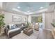 Elegant living room features a gray sectional, modern decor, and a view of the outdoor pool area at 12261 Stuart Dr, Venice, FL 34293