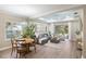 Comfortable living room with a plush gray sofa, stylish decor, and a view of the outdoor patio at 12261 Stuart Dr, Venice, FL 34293