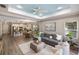 Open-concept living space combines a kitchen, dining area, and a stylish living room with modern furnishings at 12261 Stuart Dr, Venice, FL 34293