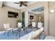 Inviting outdoor patio with comfortable seating and a view of the indoor living area with a TV at 12261 Stuart Dr, Venice, FL 34293