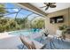 Inviting screened-in patio with a private pool, comfortable seating, and lush greenery in the backyard at 12261 Stuart Dr, Venice, FL 34293