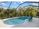 Sparkling pool with lounge chairs and a lush tropical setting at 12261 Stuart Dr, Venice, FL 34293