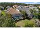 Aerial view of a screened-in pool with a patio, surrounded by lush landscaping and a well-maintained lawn at 12261 Stuart Dr, Venice, FL 34293
