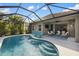 A stunning view of the screened-in pool area with outdoor seating and easy access to the interior at 12261 Stuart Dr, Venice, FL 34293