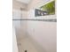 Bright shower stall features white tile, glass door, a shower head, and a horizontal accent row at 12261 Stuart Dr, Venice, FL 34293