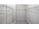 Walk-in closet featuring carpet, a small window, and white metal shelving along the walls at 12261 Stuart Dr, Venice, FL 34293