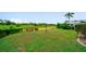 Lush backyard with deck overlooking a scenic water feature and landscaping at 1299 Tripoli, North Port, FL 34286