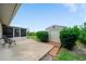 Backyard featuring a shed with mature bushes and small patio at 1299 Tripoli, North Port, FL 34286